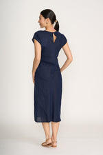 Load image into Gallery viewer, Woman wearing a navy blue dress with a cutout back on a white background
